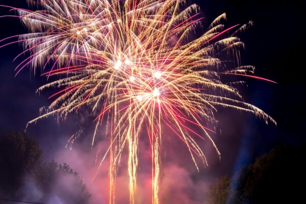 Spectacular fireworks illuminating the night sky at a festival celebration.